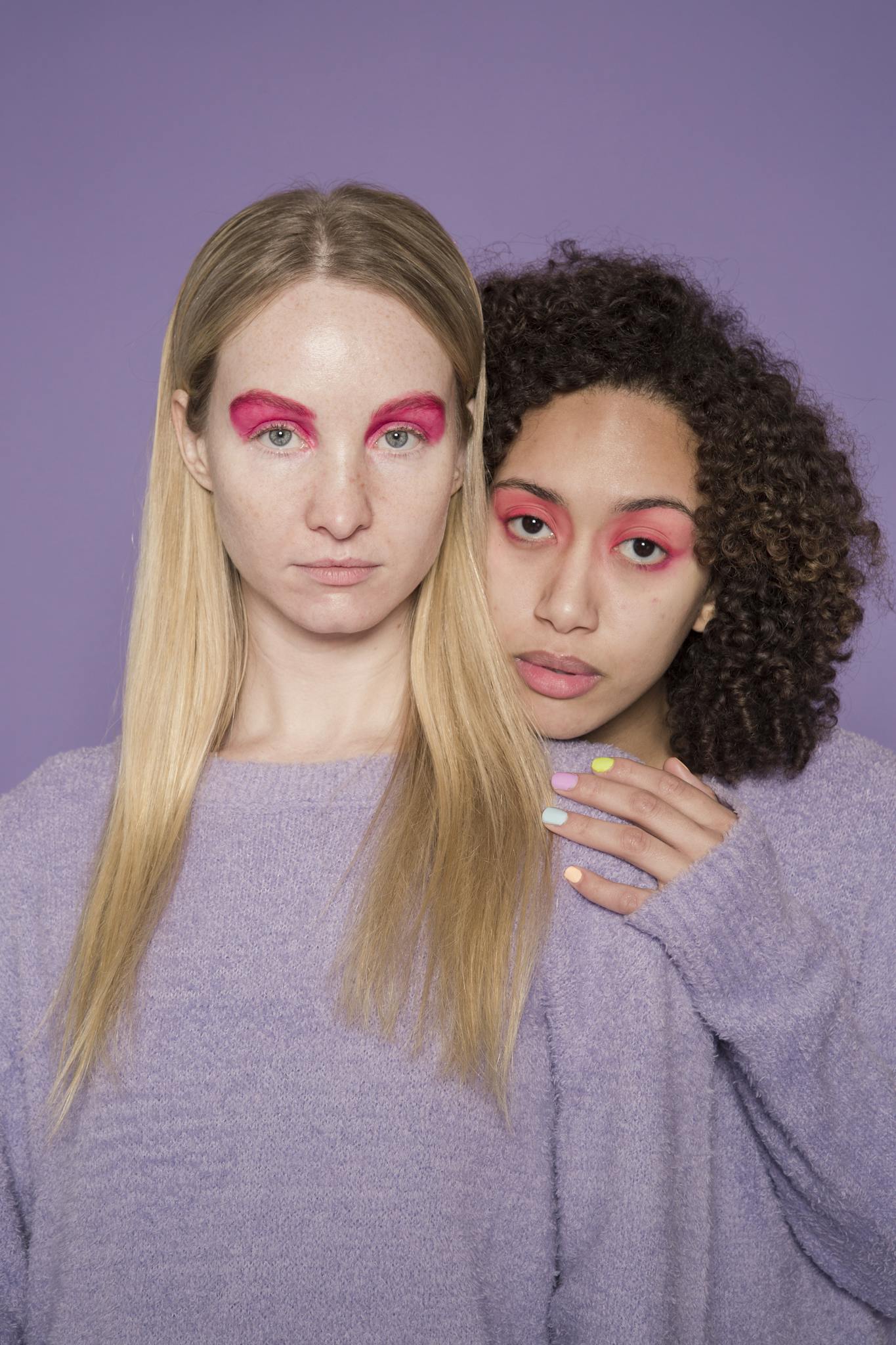 Extraordinary multiethnic women hugging in studio